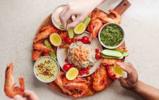 Summer seafood entertaining board full of Tassal Tiger prawns, tassel salmon and chef Guy Turlands dipping sauces